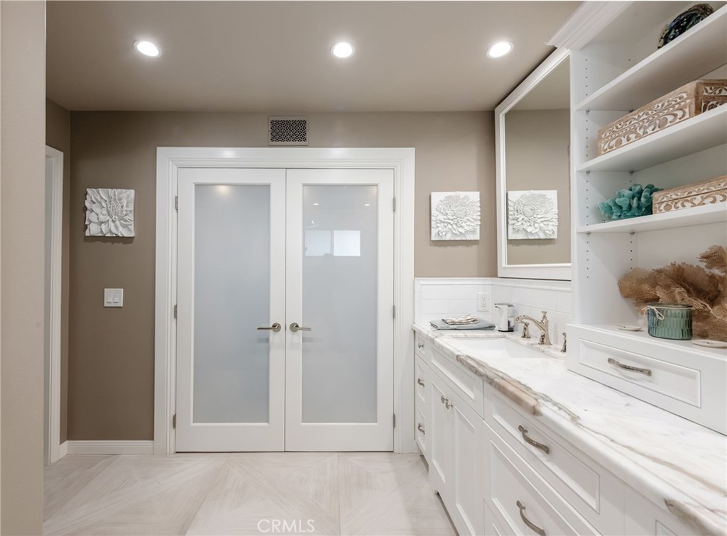 1 Santa Rosa Court Manhattan Beach, CA 90266 - Photo 17 of 28 a bathroom with a double vanity sink and a mirror