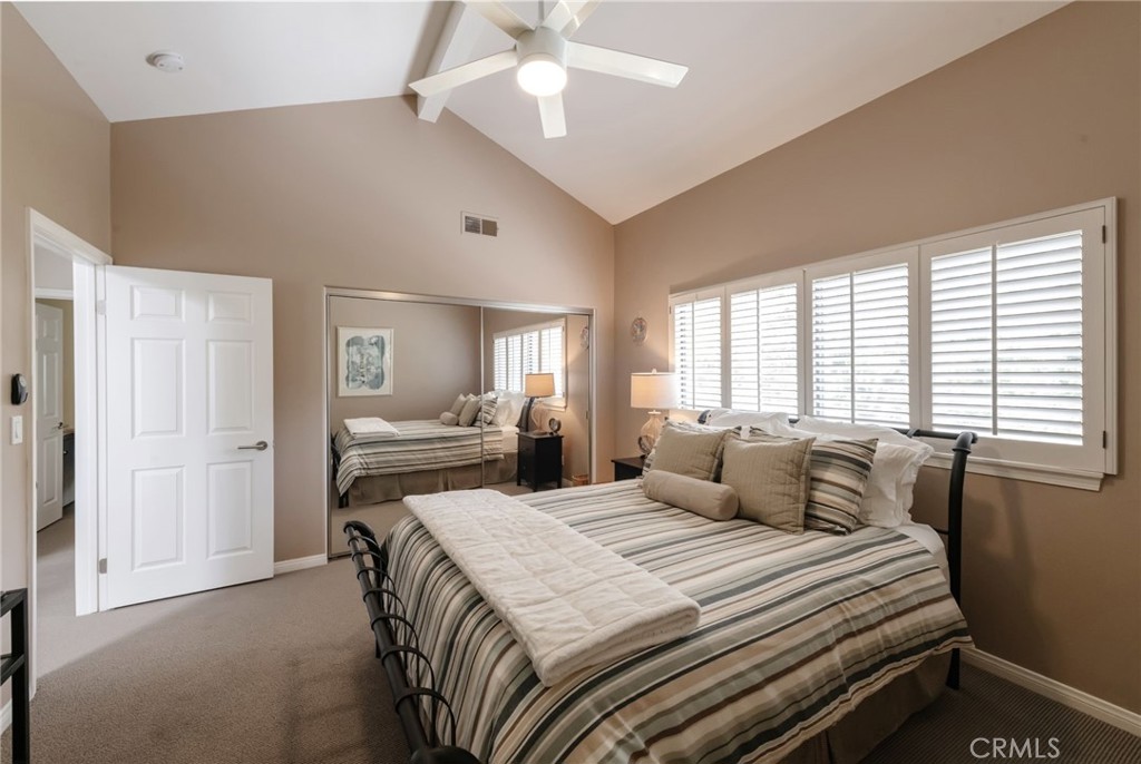 1 Santa Rosa Court Manhattan Beach, CA 90266 - Photo 18 of 28 a bedroom with a large bed and a chandelier fan
