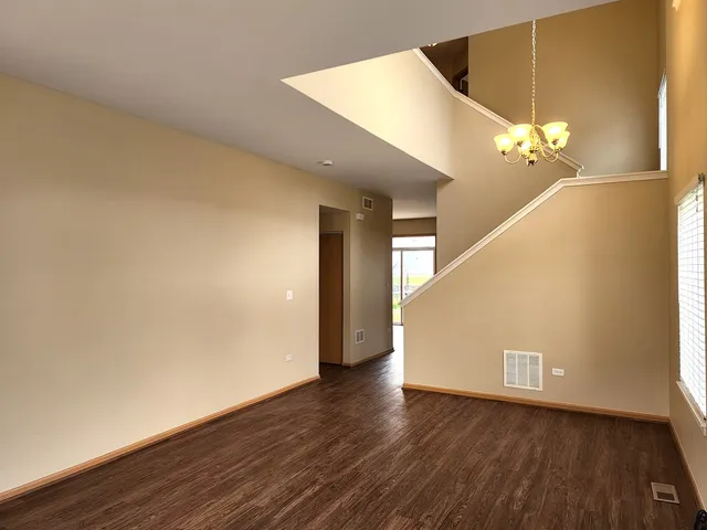 a view of a room with wooden floor and staircase