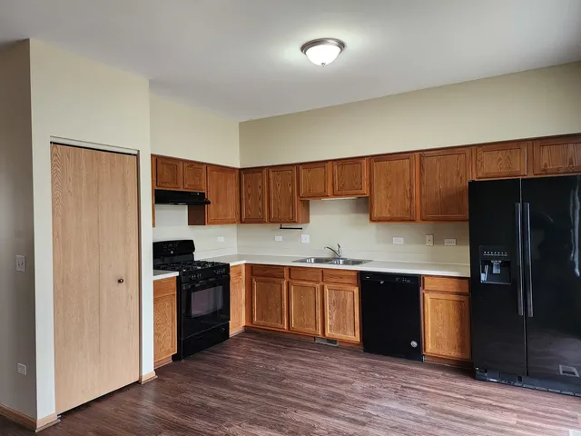a kitchen with stainless steel appliances granite countertop a stove and a refrigerator
