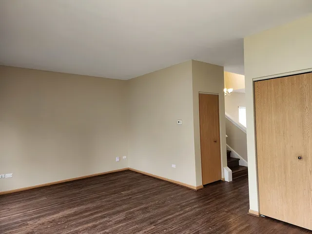 a view of an empty room and wooden floor