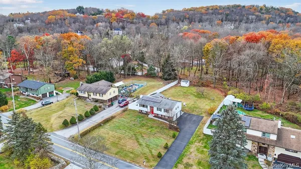 an aerial view of residential houses with outdoor space and swimming pool