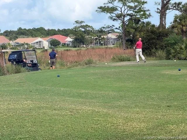 a front view of a house with a yard and lake view