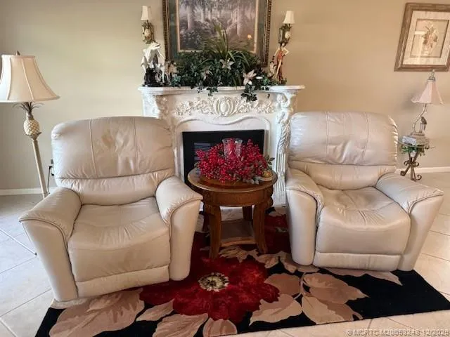 a living room with furniture a rug and a fireplace