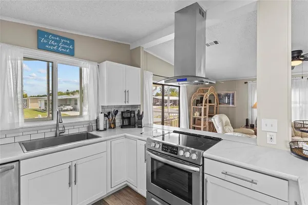 a kitchen with a stove and a white cabinets
