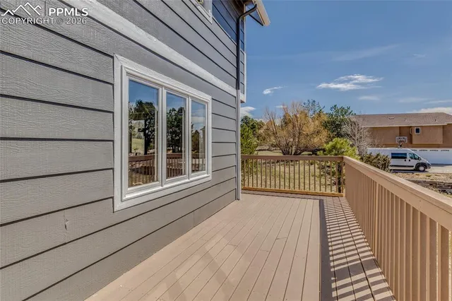 a view of a balcony with a floor to ceiling window and wooden floor