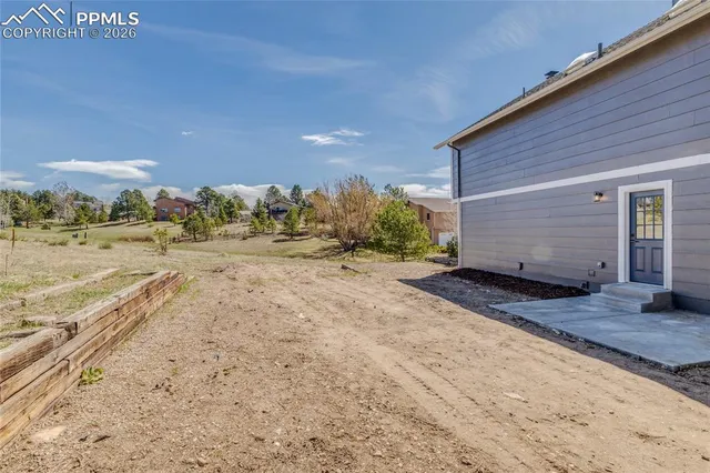 a view of a backyard of the house