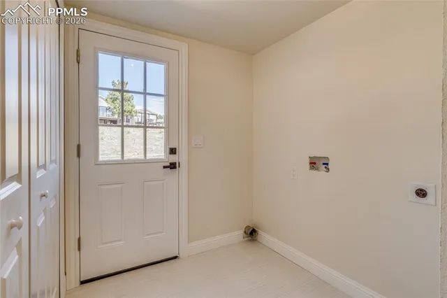 a kitchen with a refrigerator and white cabinets