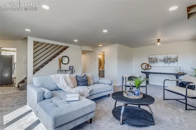 a living room with furniture and a potted plant