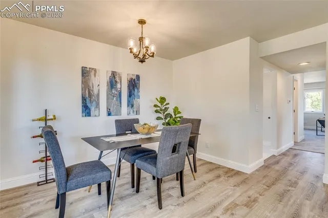 a kitchen with stainless steel appliances granite countertop a sink a stove top oven a refrigerator a center island and cabinets