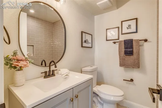 a kitchen with stainless steel appliances granite countertop a stove a sink dishwasher a refrigerator and a dining table with wooden floor