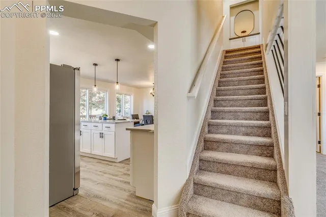 a view of entryway and hall with wooden floor