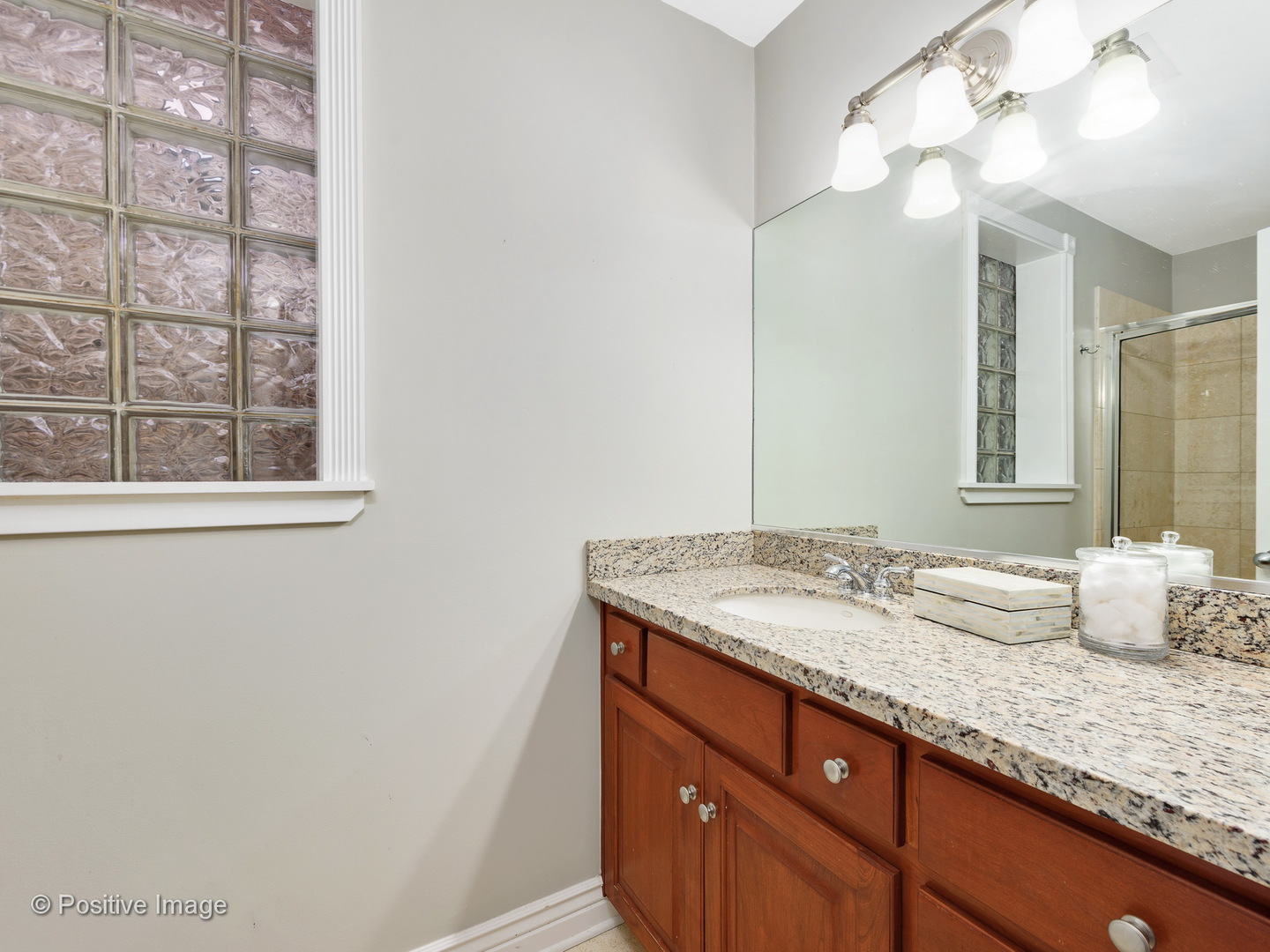 1908 North Sheffield Avenue, Unit 2 Chicago, IL 60614 - Photo 15 of 17 a bathroom with a granite countertop sink and a mirror