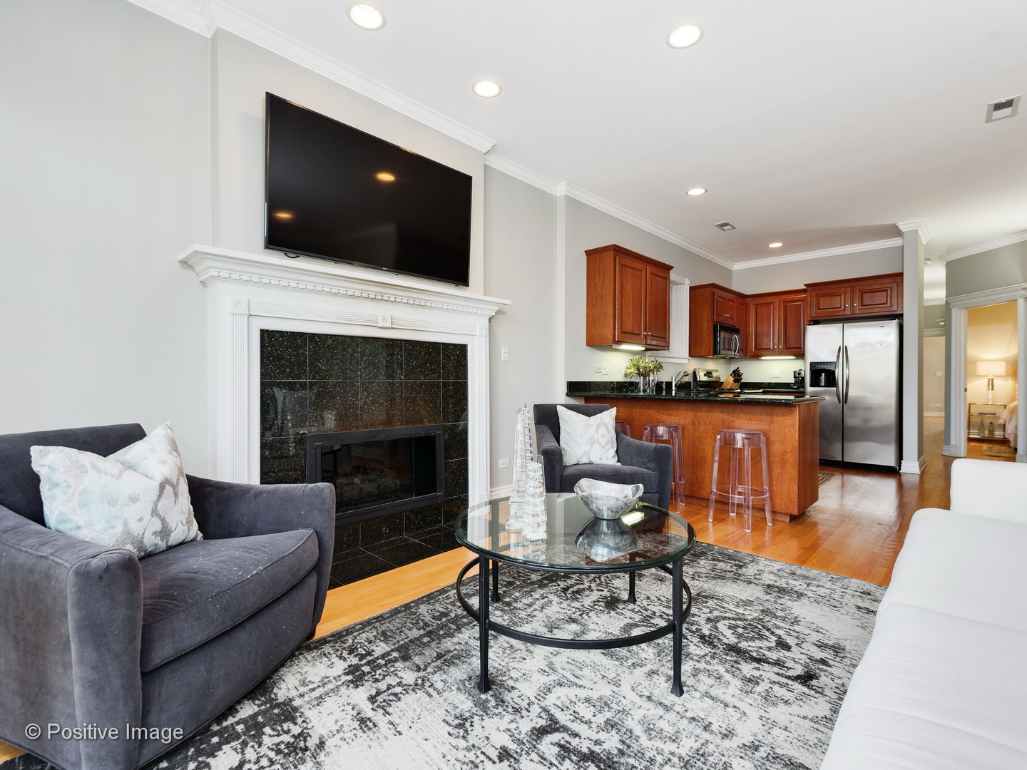 1908 North Sheffield Avenue, Unit 2 Chicago, IL 60614 - Photo 5 of 17 a living room with furniture a flat screen tv and a fireplace