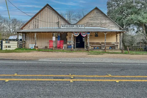 a view of a house with a porch and a yard