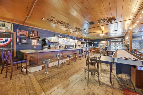 a view of a yard with an empty space and a forest