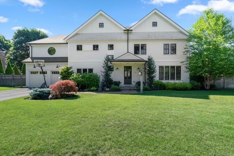a front view of house with yard and green space