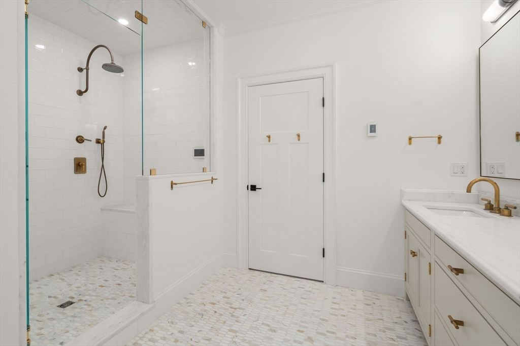 11 Fisher Avenue Wellesley, MA 02482 - Photo 18 of 35 a bathroom with a shower sink and mirror
