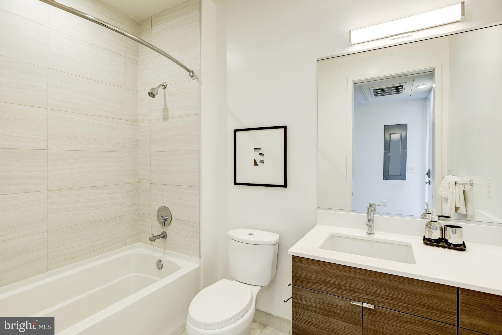 1550 11th Street Northwest, Unit 307 Washington, DC 20005 - Photo 16 of 22 a bathroom with a sink a toilet and shower