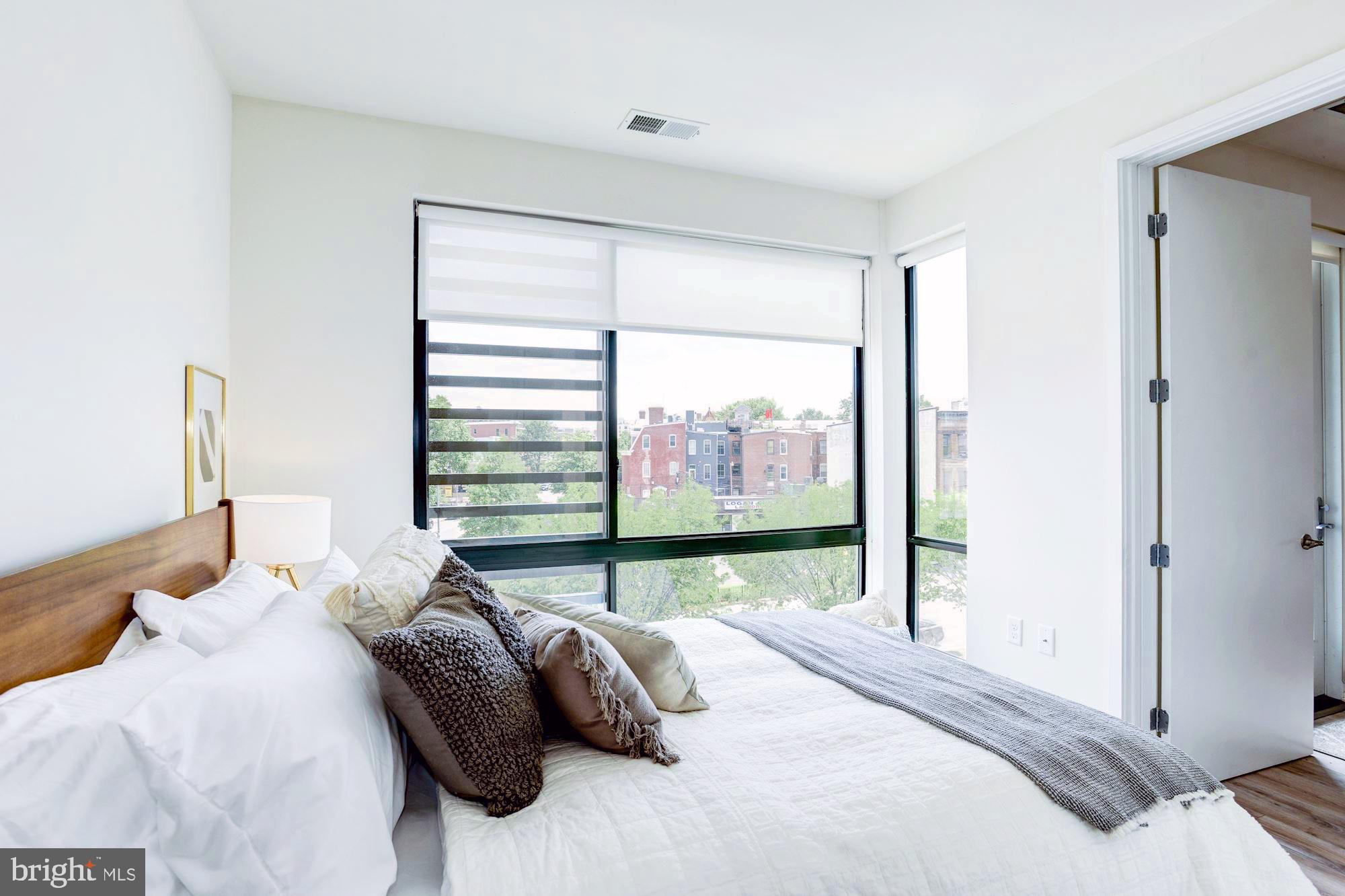 1550 11th Street Northwest, Unit 307 Washington, DC 20005 - Photo 9 of 22 a bedroom with a bed and a large window