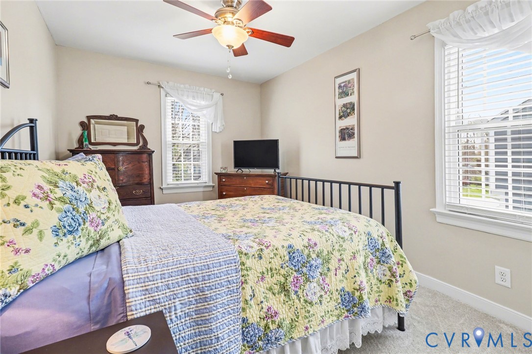 548 Glenmeadow Road Midlothian, VA 23114 - Photo 15 of 31 a bedroom with a bed and a flat tv screen on dresser