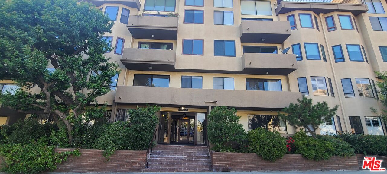1557 South Beverly Glen Boulevard, Unit 104 Los Angeles, CA 90024 - Photo 1 of 44 a front view of a multi story residential apartment building