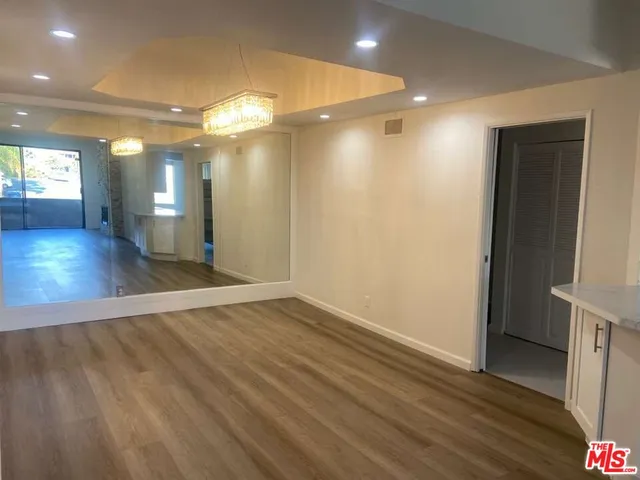 wooden floor in an empty room with a mirror