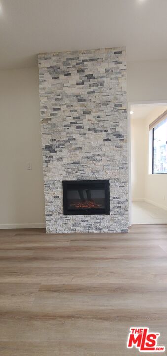 1557 South Beverly Glen Boulevard, Unit 104 Los Angeles, CA 90024 - Photo 14 of 44 a view of empty room with wooden floor and fireplace