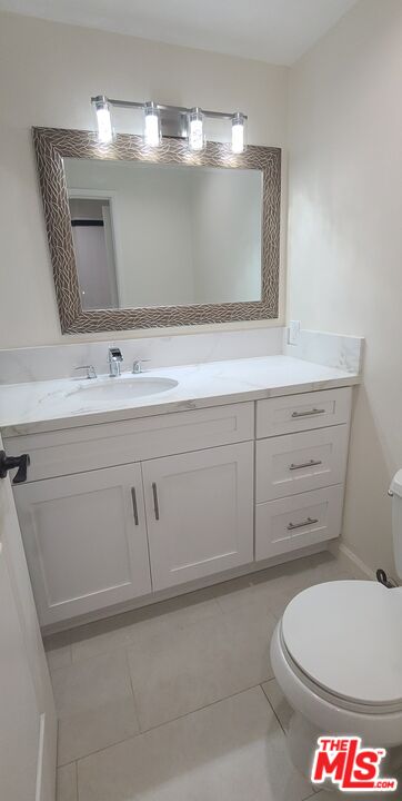 1557 South Beverly Glen Boulevard, Unit 104 Los Angeles, CA 90024 - Photo 30 of 44 a bathroom with a toilet sink and mirror