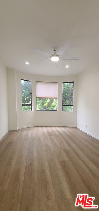 1557 South Beverly Glen Boulevard, Unit 104 Los Angeles, CA 90024 - Photo 34 of 44 wooden floor in an empty room with a window