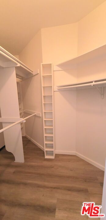 1557 South Beverly Glen Boulevard, Unit 104 Los Angeles, CA 90024 - Photo 38 of 44 a view of walk in closet with empty racks