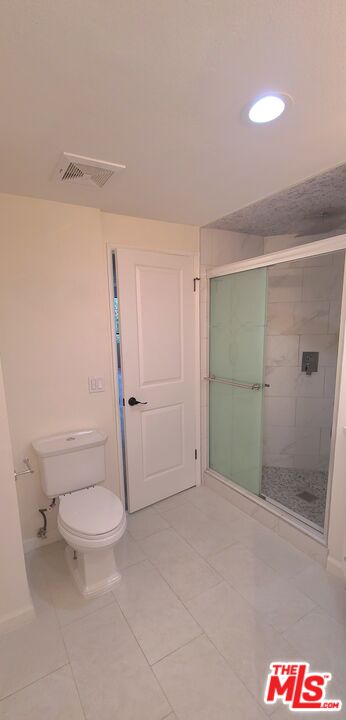 1557 South Beverly Glen Boulevard, Unit 104 Los Angeles, CA 90024 - Photo 40 of 44 a bathroom with a shower and a toilet