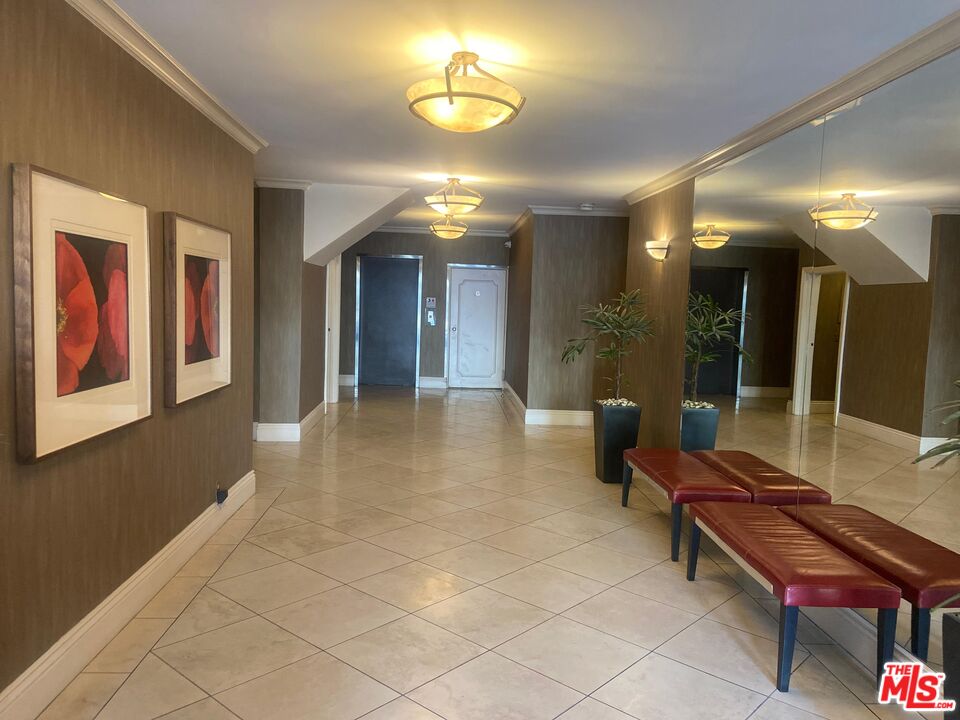 1557 South Beverly Glen Boulevard, Unit 104 Los Angeles, CA 90024 - Photo 4 of 44 a lobby with furniture and a potted plant