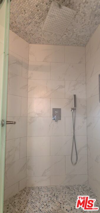 1557 South Beverly Glen Boulevard, Unit 104 Los Angeles, CA 90024 - Photo 43 of 44 a bathroom with a glass shower door
