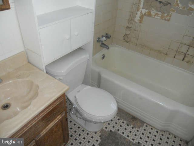1931 Quentin Road Baltimore, MD 21222 - Photo 11 of 13 a bathroom with a sink a toilet and bathtub