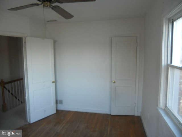 1931 Quentin Road Baltimore, MD 21222 - Photo 13 of 13 an empty room with windows