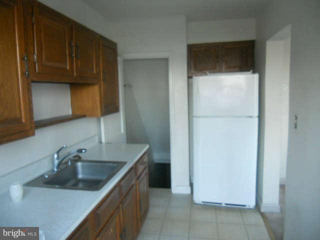 1931 Quentin Road Baltimore, MD 21222 - Photo 4 of 13 a kitchen with a sink and cabinets