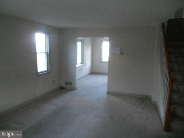 1931 Quentin Road Baltimore, MD 21222 - Photo 5 of 13 an empty room with windows