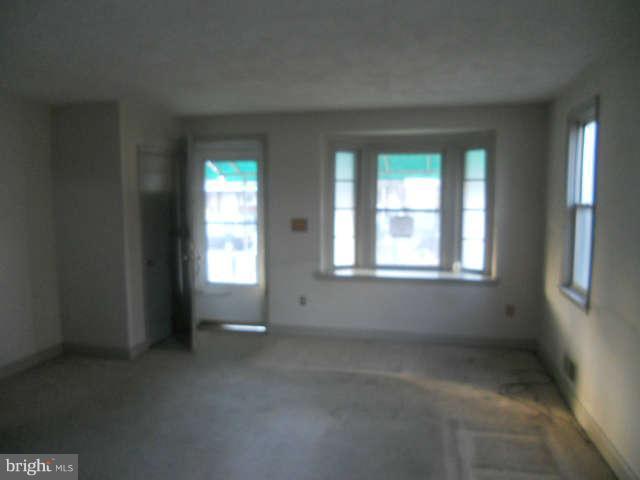1931 Quentin Road Baltimore, MD 21222 - Photo 6 of 13 an empty room with windows