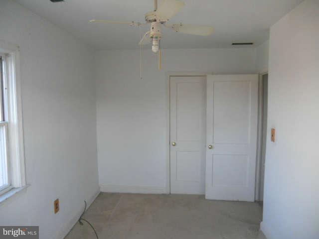 1931 Quentin Road Baltimore, MD 21222 - Photo 9 of 13 an empty room with a window