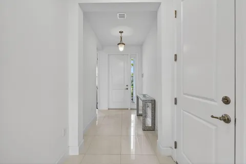 a view of a hallway with closet and a fireplace