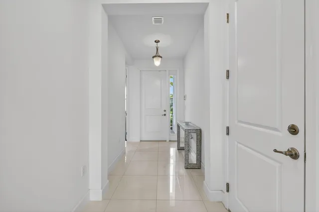 a view of a hallway with closet and a fireplace
