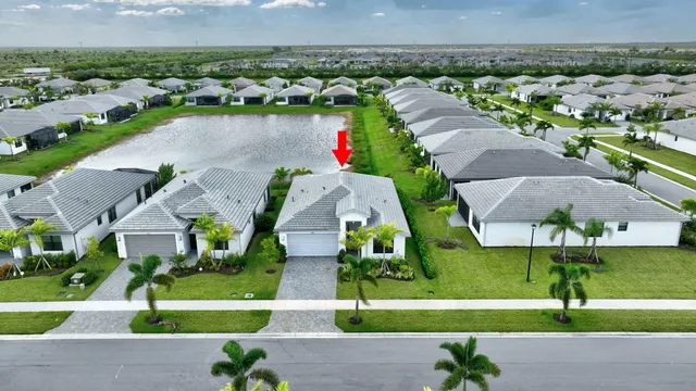 an aerial view of house with yard swimming pool and outdoor seating