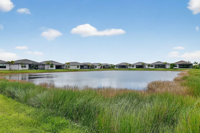 a view of a lake with houses in the back