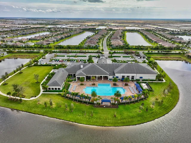 an aerial view of residential houses with outdoor space and swimming pool