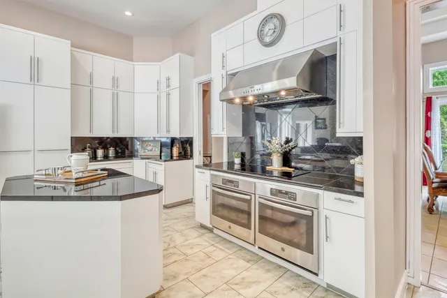 a kitchen with stainless steel appliances granite countertop a sink and cabinets