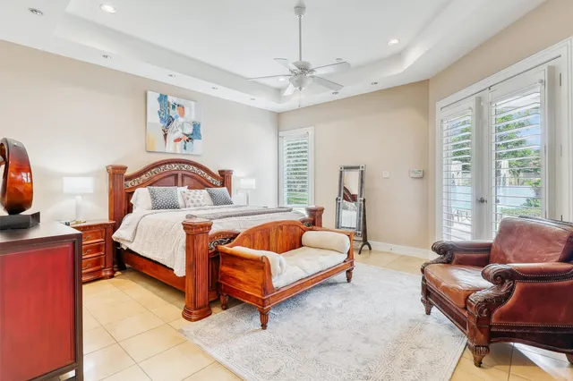 a bedroom with furniture and a large window