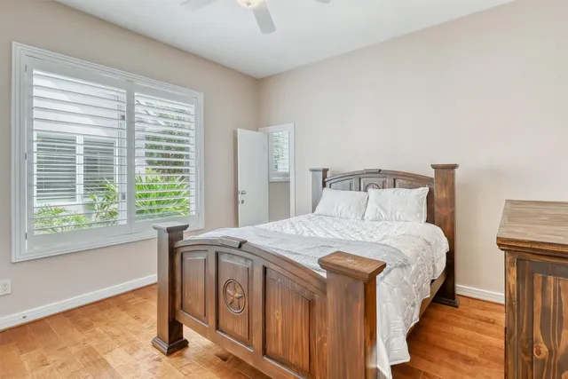a bedroom with a bed next to a window