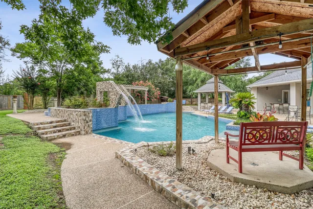 a view of a house with swimming pool and a yard