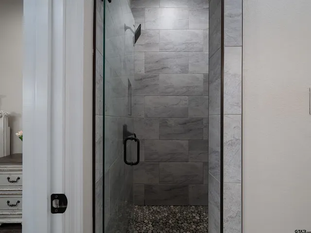 a bedroom with a bed and a chair